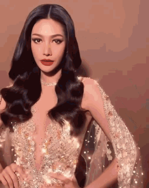a woman with long black hair is wearing a very fancy dress