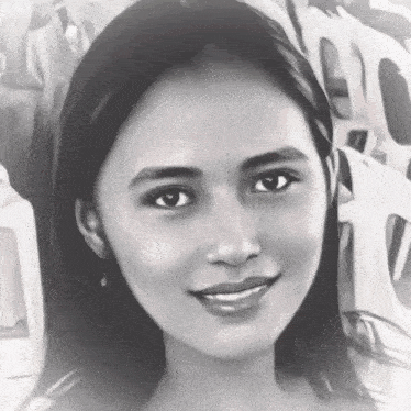 a black and white photo of a woman smiling in front of chairs .