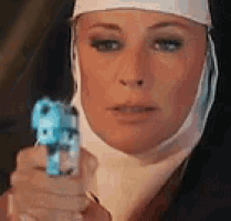 a nun is holding a blue gun in her hand and pointing it at the camera .