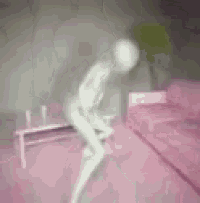 a naked person is sitting on a pink couch in a room .