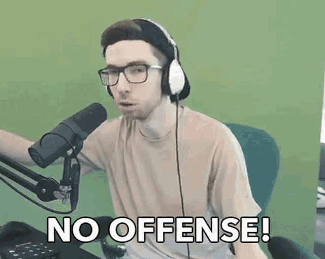 a man wearing headphones says no offense in front of a microphone