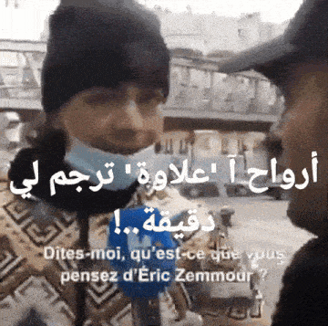a man wearing a mask talks to another man