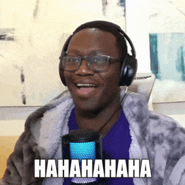 a man wearing headphones and glasses is laughing and has the word  hahaha written on the bottom of his face
