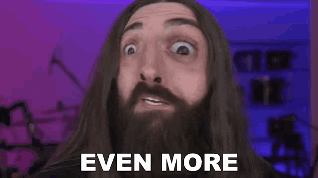 a man with a beard and long hair is making a funny face and saying `` even more '' .