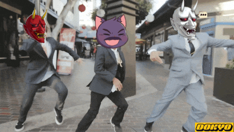 three men in suits are dancing in front of a sign that says dokyo