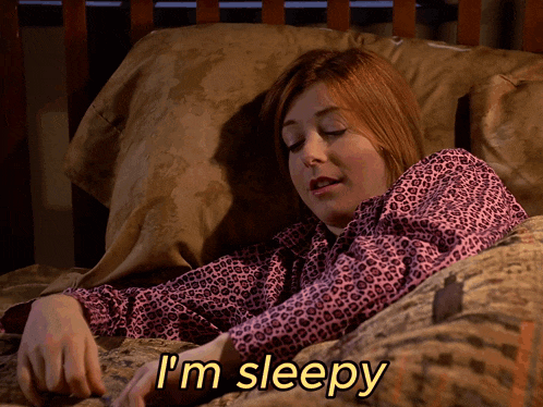 a woman laying in bed with the words i 'm sleepy written on the bottom