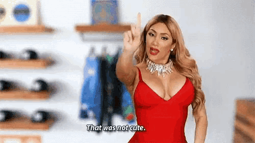 a woman in a red dress is giving the middle finger and saying `` that was not cute . ''