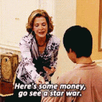 a woman is shaking hands with a man and saying here 's some money go see a star war .