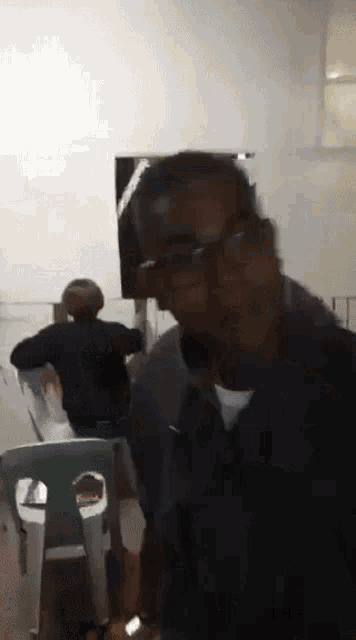 a man wearing glasses is making a funny face