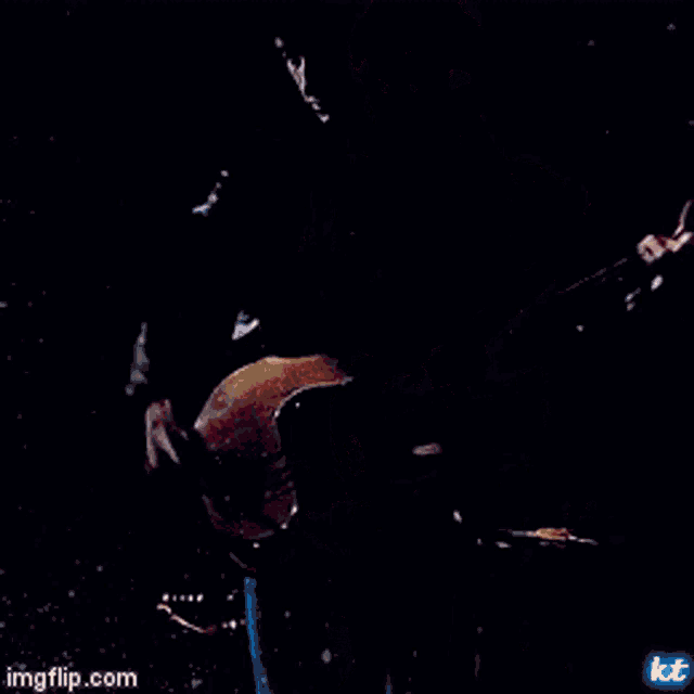 a man is playing a guitar on a stage with a microphone .