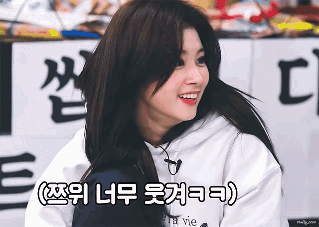 a woman wearing a white hoodie with the word vie on the front