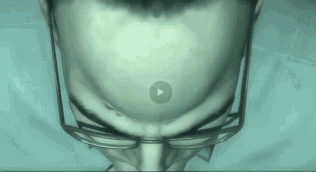 a close up of a person 's face with a play button