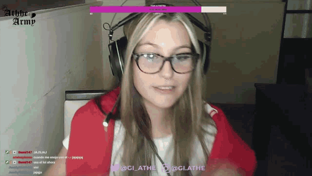 a woman wearing glasses and headphones is sitting in front of a screen that says the aether army