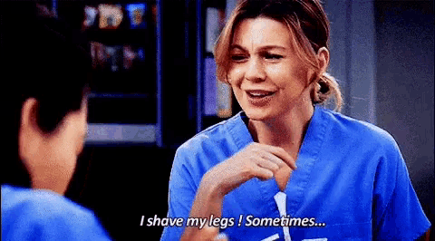 a woman in a blue scrub top is talking to a man and says `` i shave my legs sometimes ... ''