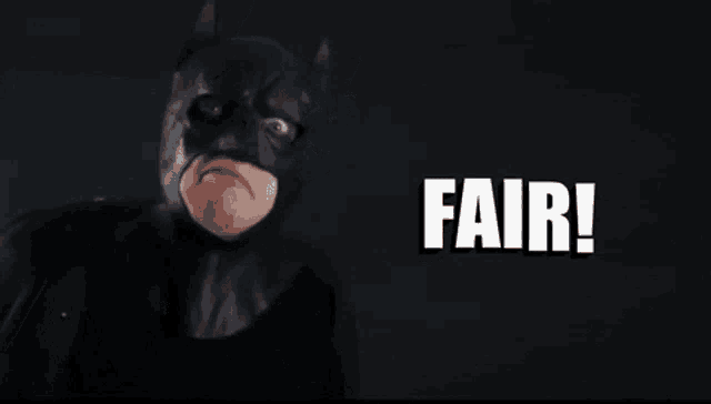 a man in a batman mask says " fair " in white letters