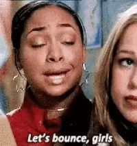 two women are standing next to each other and one of them is saying `` let 's bounce girls '' .