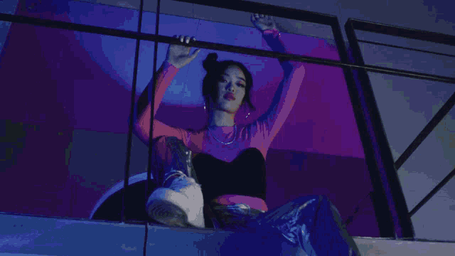a woman wearing a white top and leopard print sleeves is standing in front of a lighted wall