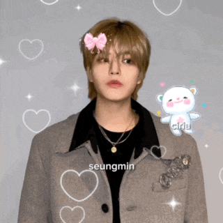 a young man with the name seungmin on the bottom of his jacket