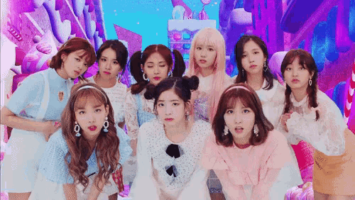 a group of girls are posing for a picture together in front of a candy land .