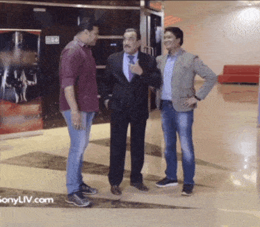 three men are standing next to each other with the website sonyliv.com in the corner