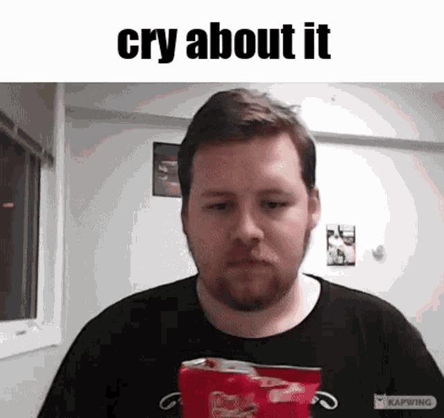 a man with a beard is holding a bag of doritos and crying .