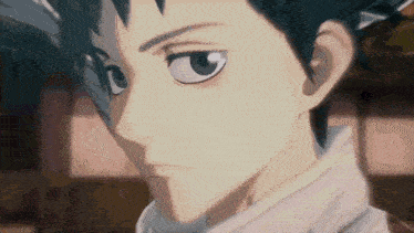 a close up of a boy 's face with a serious look on his face