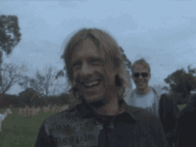 a man wearing a shirt that says tomorrow people smiles for the camera