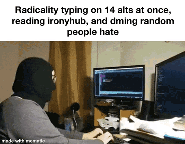 a man wearing a mask is typing on a keyboard in front of two monitors