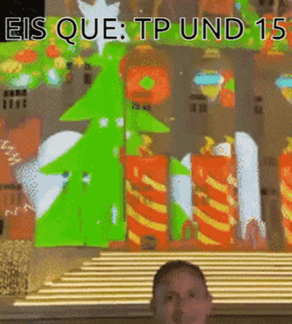 a man is standing in front of a screen that says " eis que tp und 15 "