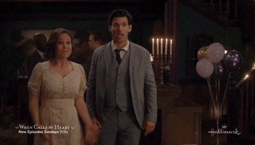 a man and a woman are standing next to each other with the words when calls the heart below them