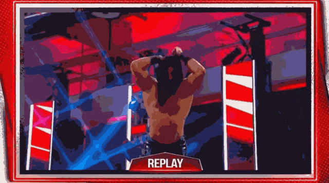 a replay of a wrestling match is shown on a television screen