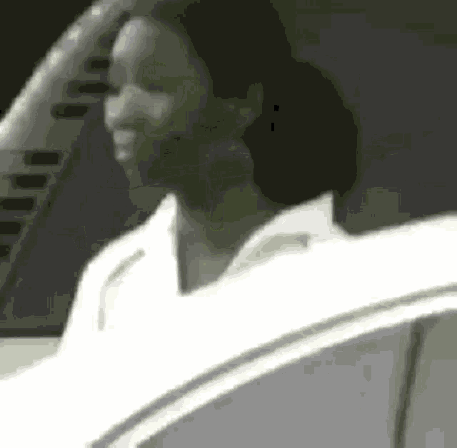 a woman is sitting in the driver 's seat of a white car .