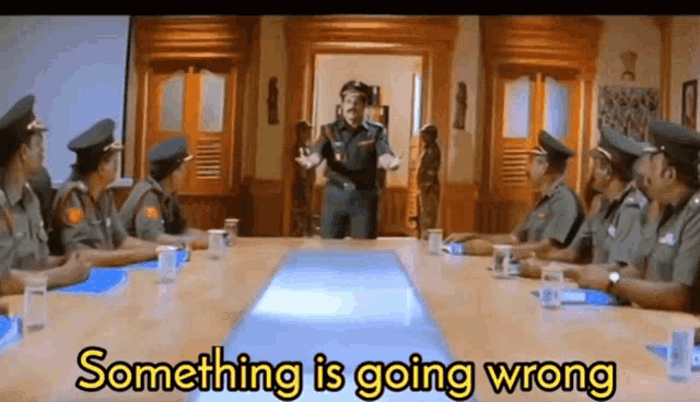 a group of police officers sitting around a table with the words something is going wrong written on the bottom