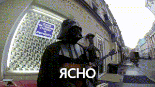 a man in a darth vader costume is playing a guitar on the street