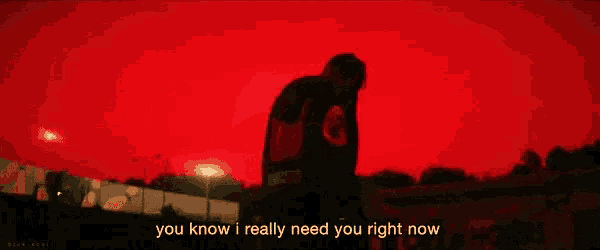 a man is standing in front of a red sky with the words " you know i really need you right now " below him