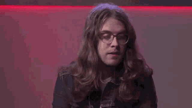 a man with long hair and glasses is asking the question " why does this "