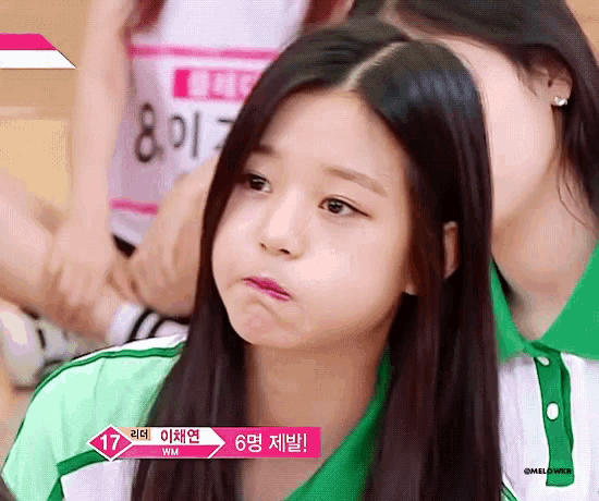 a girl with long hair is making a funny face while another girl looks on .