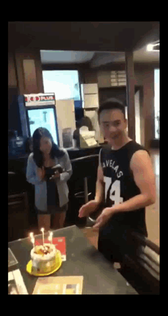 a man in a black tank top with the number 14 on it
