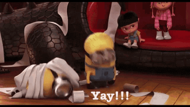 a yellow minion laying on a pile of toilet paper with the words yay written below him