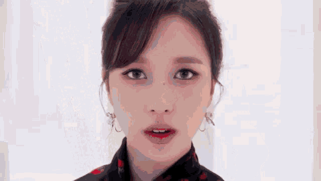 a close up of a woman 's face with a white background .