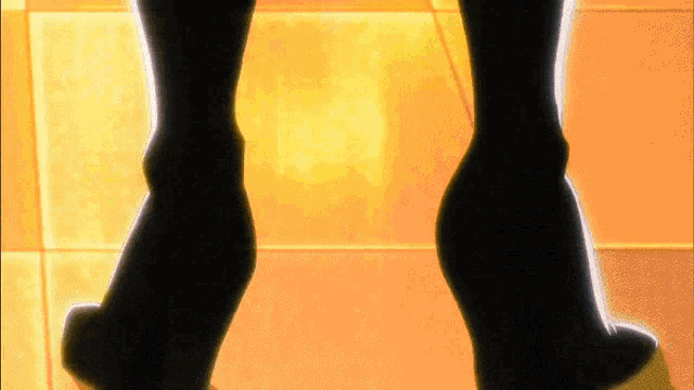 a woman 's feet are shown in a silhouette against a yellow background