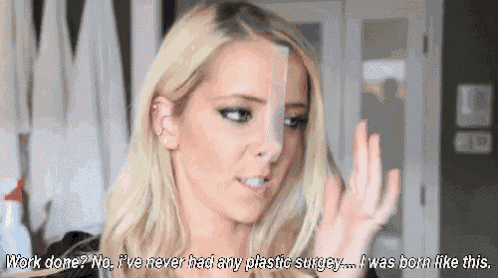 a blonde woman is wearing a plastic surgery tape on her nose .