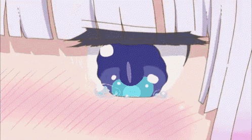 a cartoon girl with white hair and blue eyes is sitting in a classroom with a name tag .