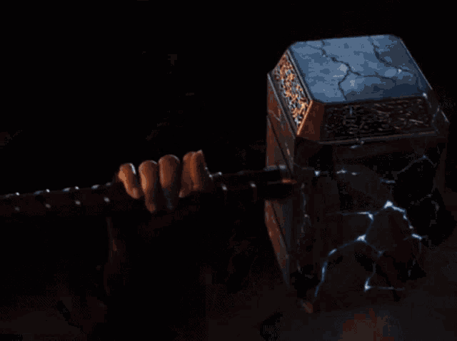 a woman in a mask holds a hammer in her hand