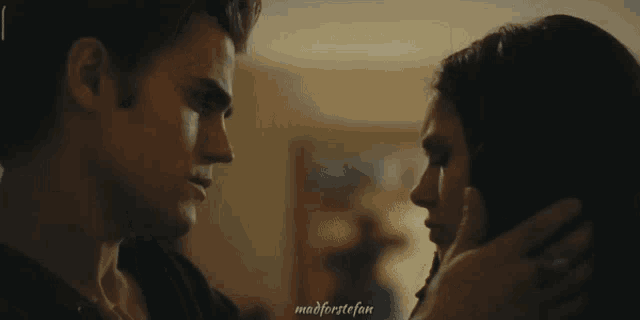 a man kissing a woman in a hallway with the words madforstefan written on the bottom