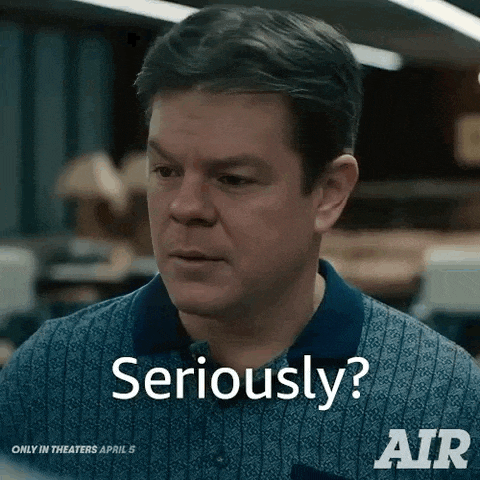 a man in a blue shirt is making a funny face and says `` seriously ? ''