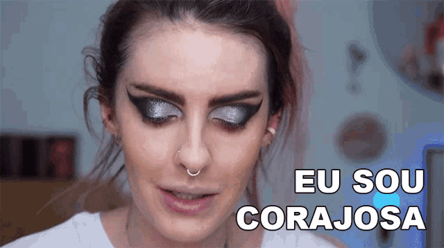 a woman with makeup and the words eu sou corajosa