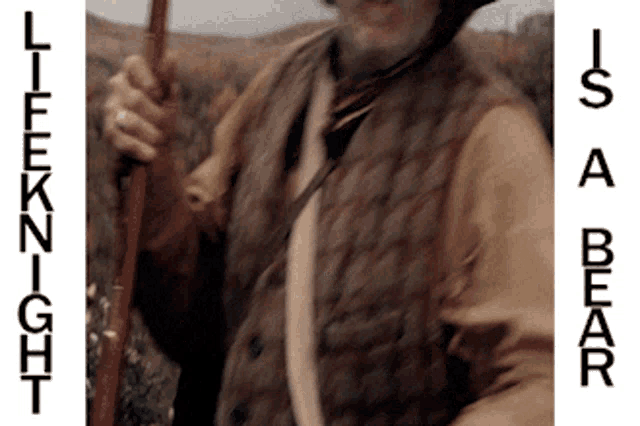 a man holding a stick with the words lifeknight and is a bear