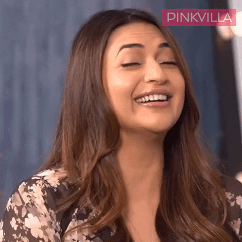 a close up of a woman 's face with a pinkvilla logo in the background
