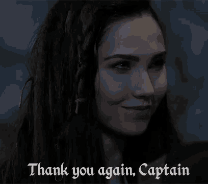 a woman says thank you again captain in front of a dark background